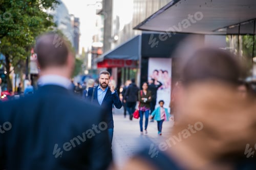Preview: Hipster manager with smart phone walking in the street