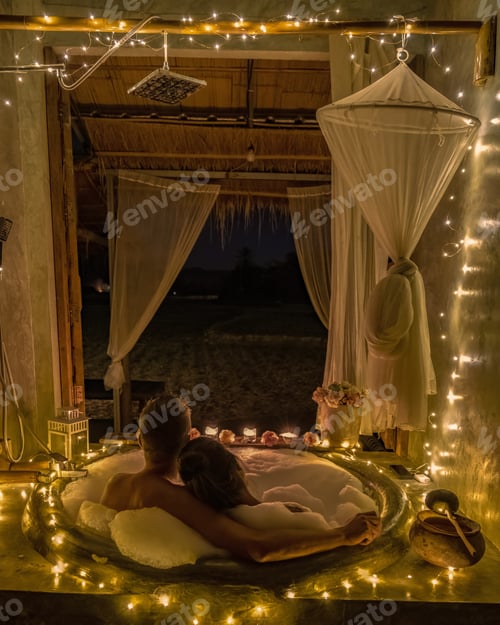 Preview: a couple of men and women in a bathtub with Christmas lights on the countryside of Nan Thailand