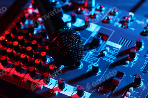 Preview: Professional mixing console with microphone on table in neon lights, closeup