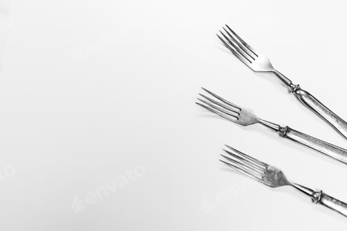 Preview: Old metal forks isolated on a white background.
