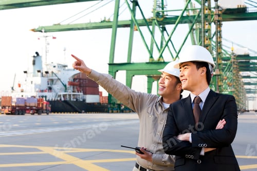 Preview: shipping industry worker showing a businessman around the port