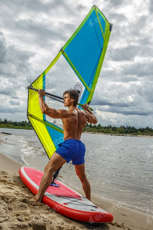 Preview: Muscular surfer posing with surfboard.