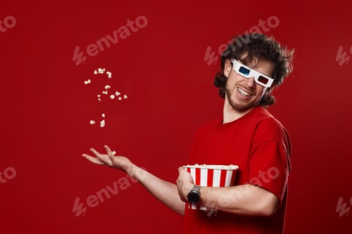 Preview: man in 3d glasses, red t-shirt throwing up and eating popcorn