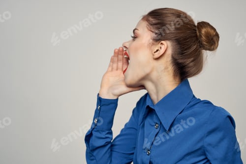Preview: Portrait of a beautiful woman with red lips on a light background and a blue shirt cropped view