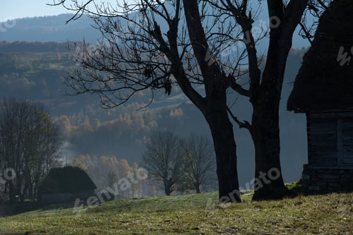 Preview: Autumn countryside landscape with wooden houses, thatched roof
