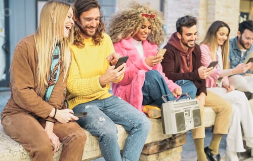 Preview: Group happy friends using mobile smartphones in the city