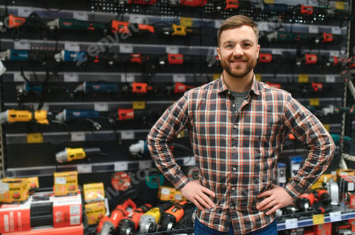 Preview: handsome young man shopping for tools at hardware store