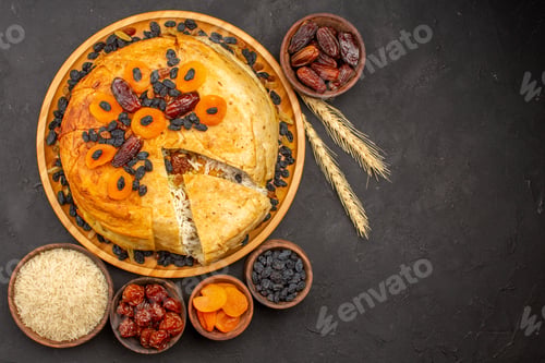 Preview: top view shakh plov delicious rice meal cooked inside round dough with raisins on dark grey