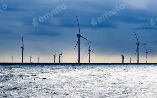 Preview: NORTHSEA Wind turbines rising above the shimmering sea at dusk