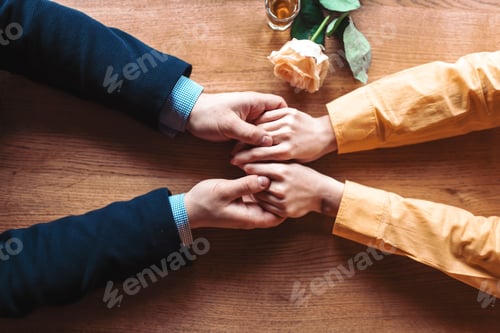 Preview: Love couple hands on wooden background