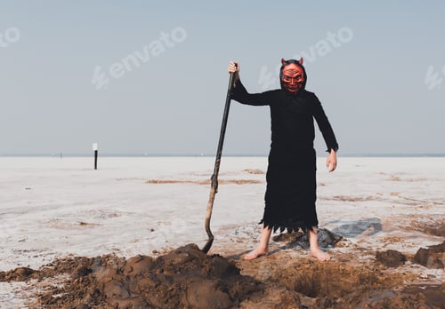 Preview: A boy wearing a scary devil costume and holding a shovel at the salt plains in Oklahoma, USA