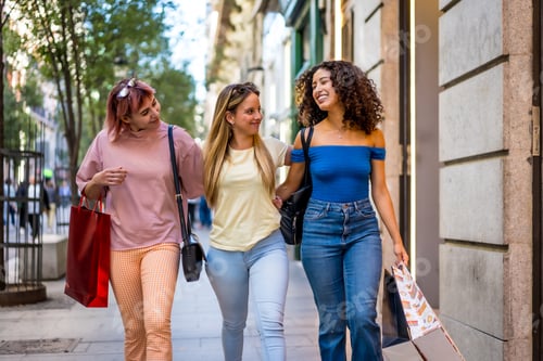 Preview: Happy women shopping in the city together