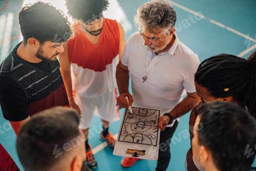 Preview: Top view of basketball coach explaining game plan with interracial team.