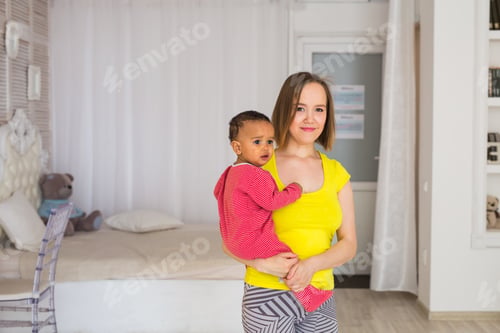 Preview: Woman Holds Baby in Light, Airy Room