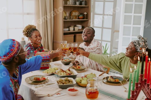 Preview: Group of Black Adults Celebrating Kwanzaa and Toasting Around Festive Table