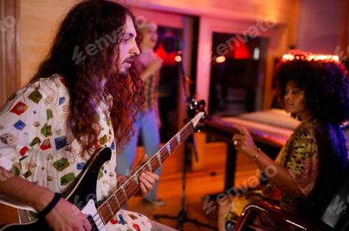 Preview: Professional bass guitarist is playing at music recording studio.