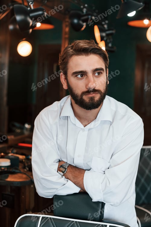 Preview: Handsome man with beard is in the barber shop