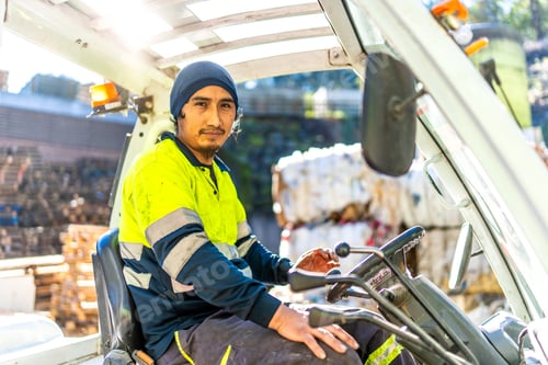 Preview: Man driving a forklift outside a recycling plant