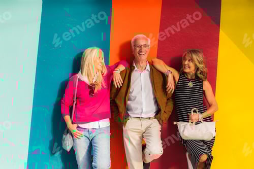 Preview: Smiling Mature Friends Posing Against Colorful Wall