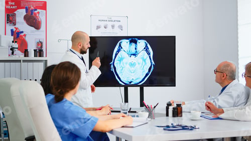 Preview: Cvalified bearded head doctor explaining brain structure using monitor