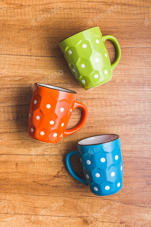 Preview: The polka dot mug on wooden table. Top view.