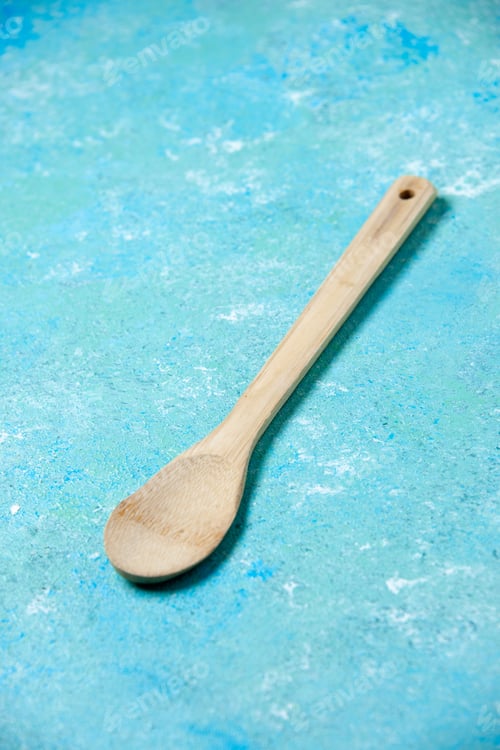 Preview: bottom view wooden spoon on blue background