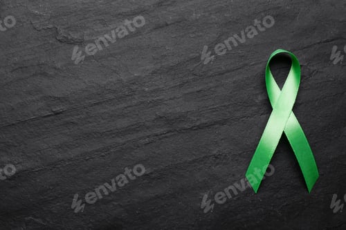 Preview: World Mental Health Day. Green ribbon on black background, top view with space for text