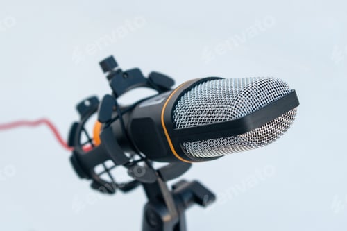 Preview: Closeup of a black and grey microphone on a white surface and background