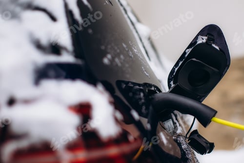 Preview: Electric vehicle charging in winter snow with connection plug