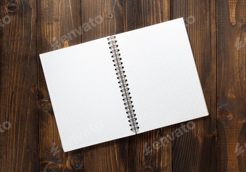 Preview: checked notebook on brown wood