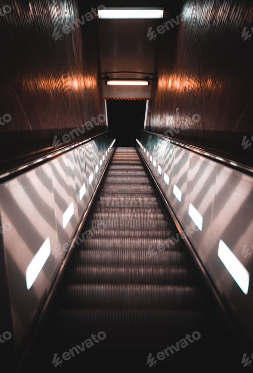 Preview: Vertical dark shot of an escalator in a building