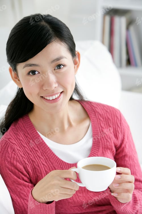 Preview: Young Chinese woman with a cup of coffee