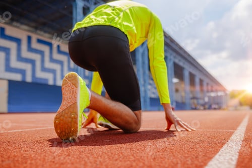 Preview: Runner at Starting Line Preparing for Sprint Race on Outdoor Stadium Track