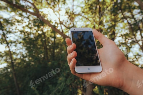 Preview: Close up of a man using mobile smart phone outdoor