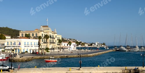 Preview: Spetses island, Greece. Seafront buildings and motor boats taxis at small port of Dapia