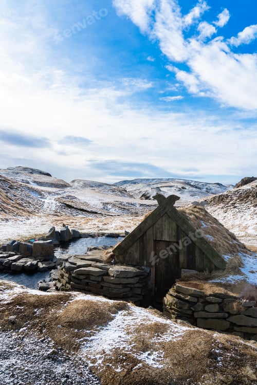 Preview: Landscape of an island hot springs with a man alone bathing in the natural pool.