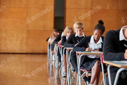 Preview: Teenage Students In Uniform Sitting Examination In School Hall
