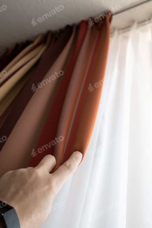 Preview: Male hand closes the blackout curtains on the window. Close-up.