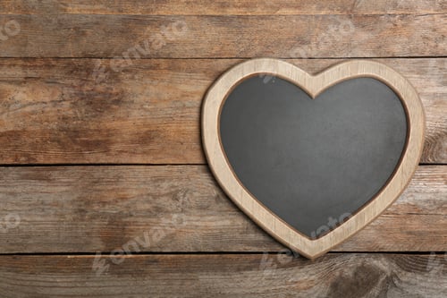 Preview: Heart shaped chalkboard on wooden background, top view with space for text
