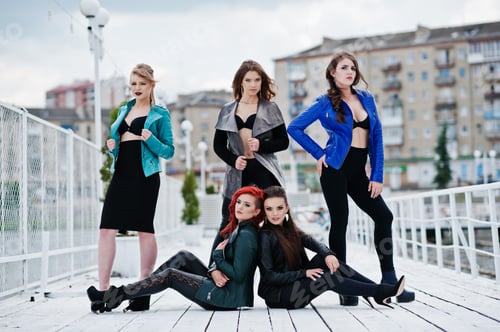 Preview: Group of sexy models girls in black bra and leather jackets on the dock