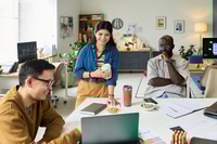 Preview: Multiethnic Adults Collaborating on Project in Modern Office Workspace
