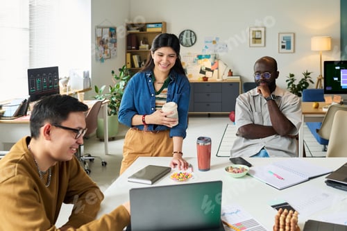 Preview: Multiethnic Adults Collaborating on Project in Modern Office Workspace
