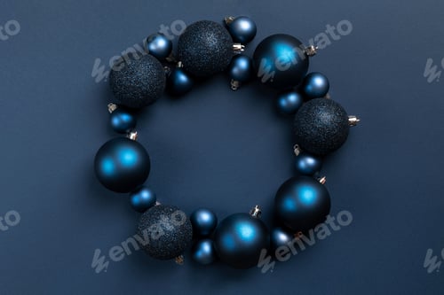Preview: Circle frame of blue Christmas balls on blue background