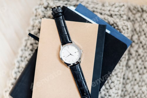 Preview: Closeup of watch on notepads