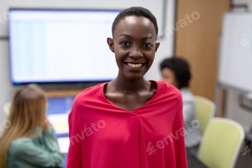 Preview: Portrait of african american businesswoman in meeting room looking to camera and smiling