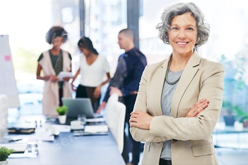 Preview: Portrait of a businesswoman standing in an office with her colleagues in the background