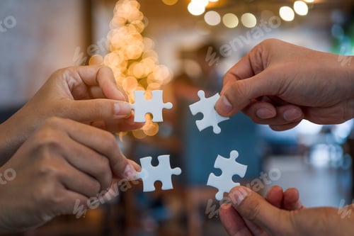 Preview: team hand power full hand placing the jigsaw puzzle piece for conect business partner a