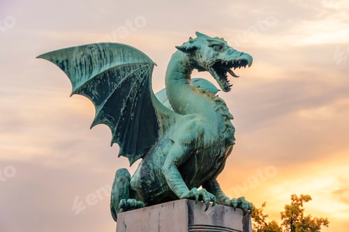Preview: A green dragon statue with outstretched wings against a twilight sky on the Dragon Bridge