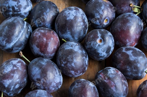 Preview: Ripe Plums on a Wooden Background