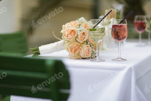 Preview: Bride wedding flowers on the table while celebrating